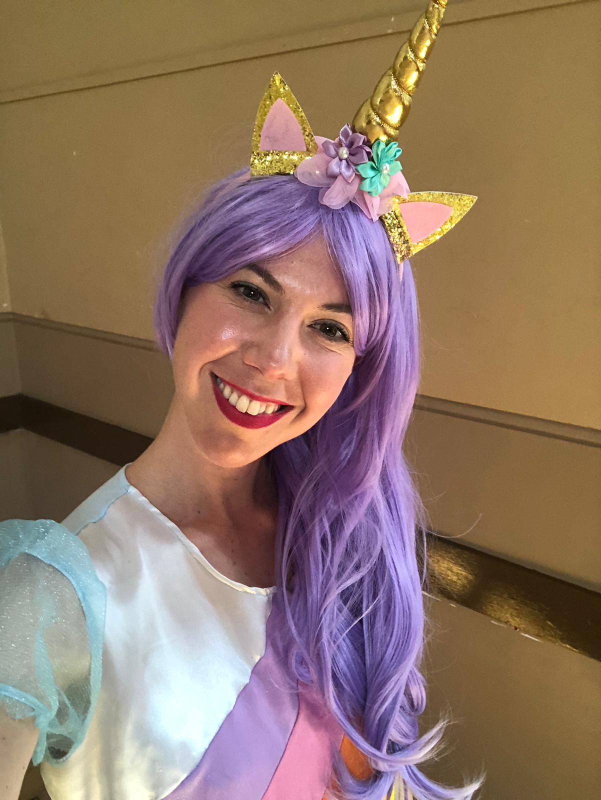 Anna dressed for a colourful unicorn story party
